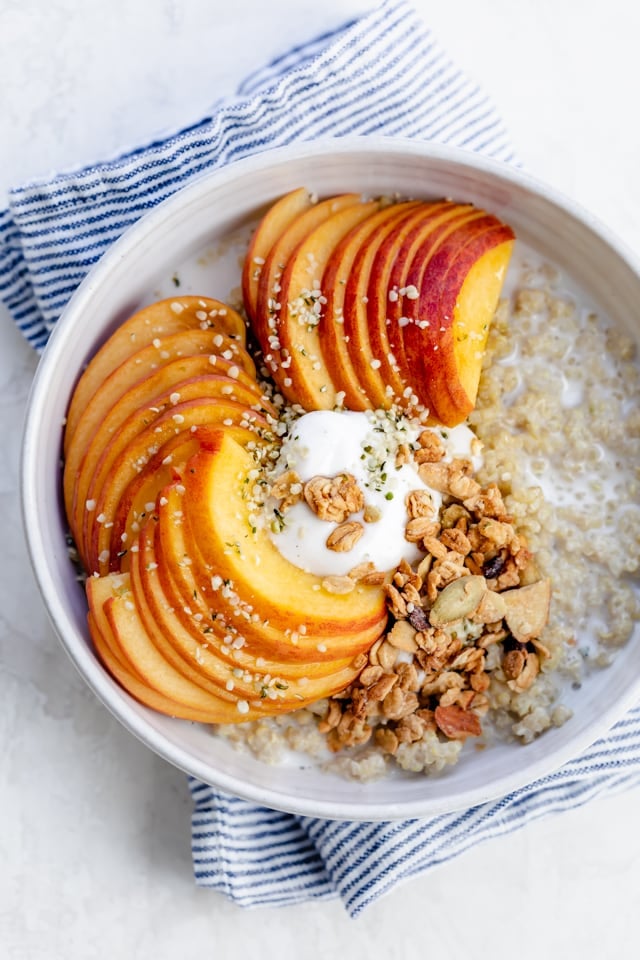 Quinoa breakfast bowl with peaches, yogurt and granola