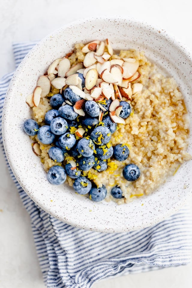 Quinoa breakfast bowl with blueberries, lemon zest and almonds