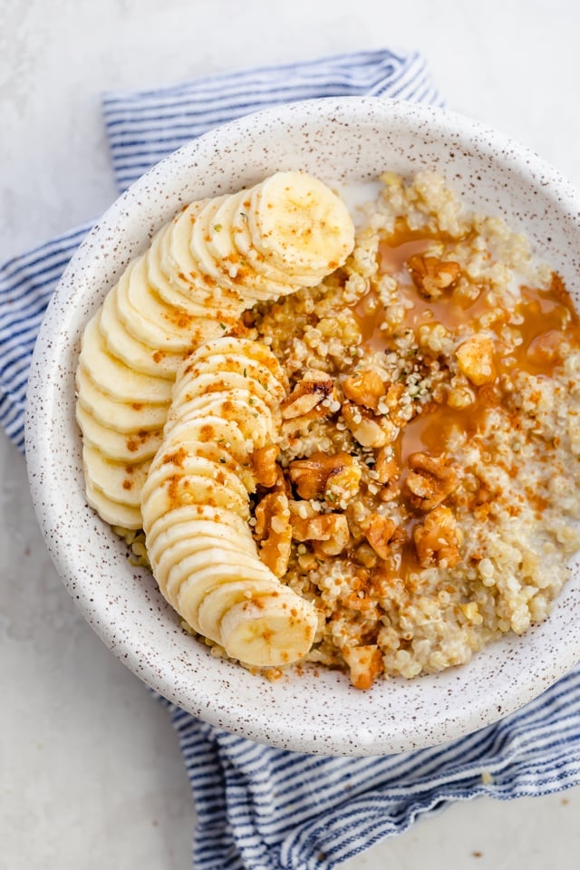 Quinoa breakfast bowl with bananas, walnuts, cinnamon and caramel sauce