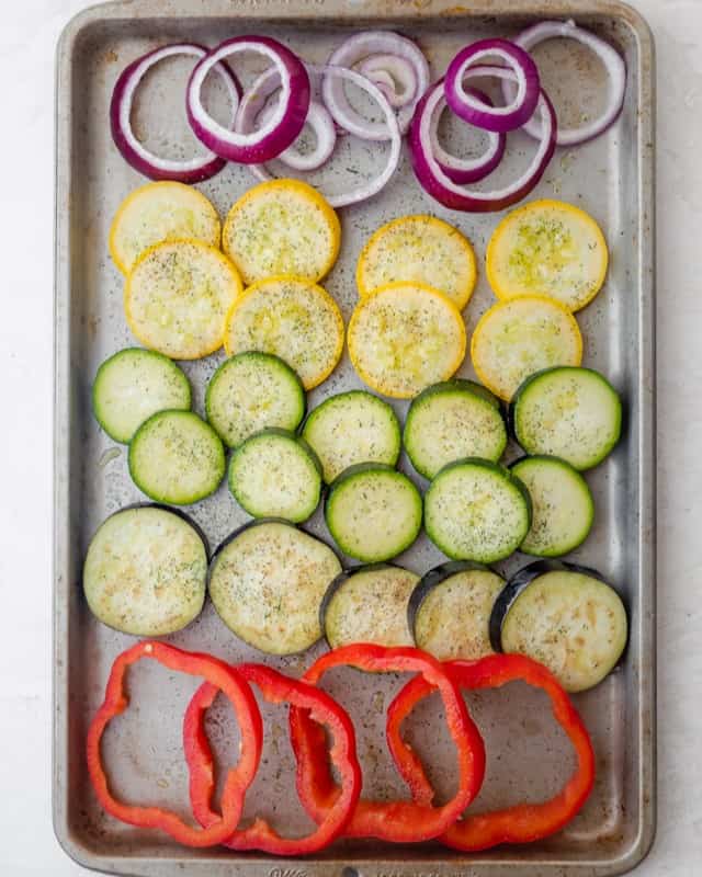 Vegetables lined on a baking dish.