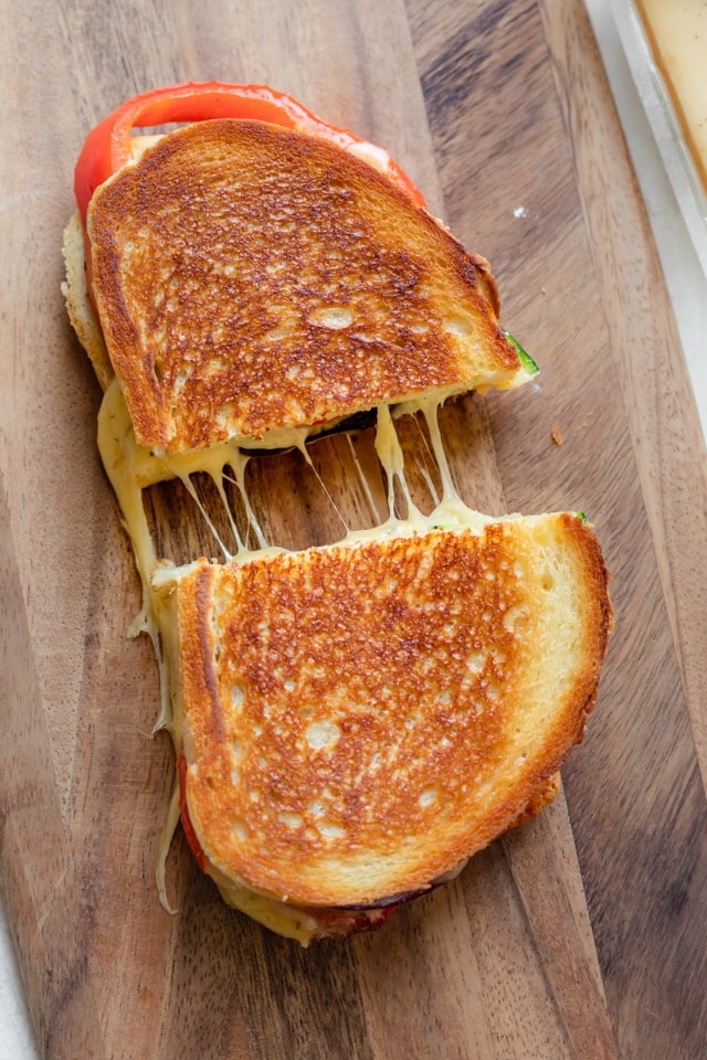 Completed grilled cheese sandwich on a cutting board