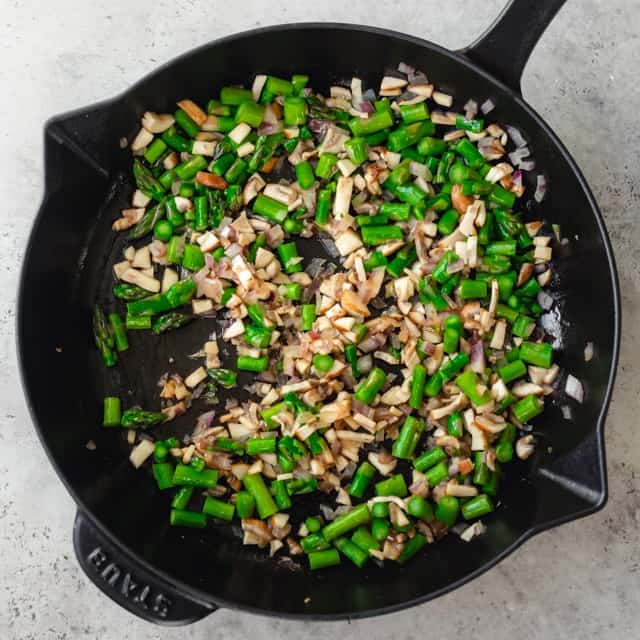 Veggies cooking in a pan.