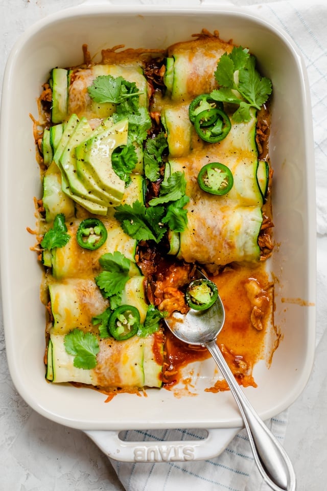 Dish of enchiladas with two rolled removed