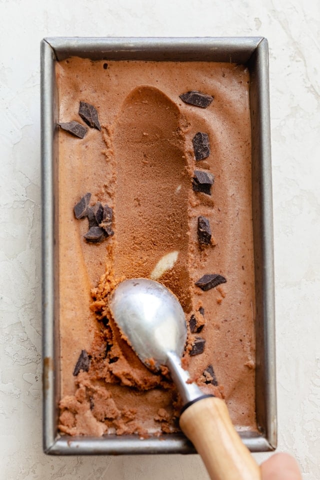 Nice cream in loaf pan after freezing; scoop getting scooped out with ice cream scooper