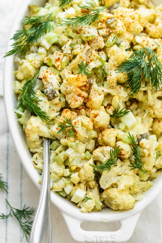 Close up shot of the cauliflower potato salad with a spoon scooping out some