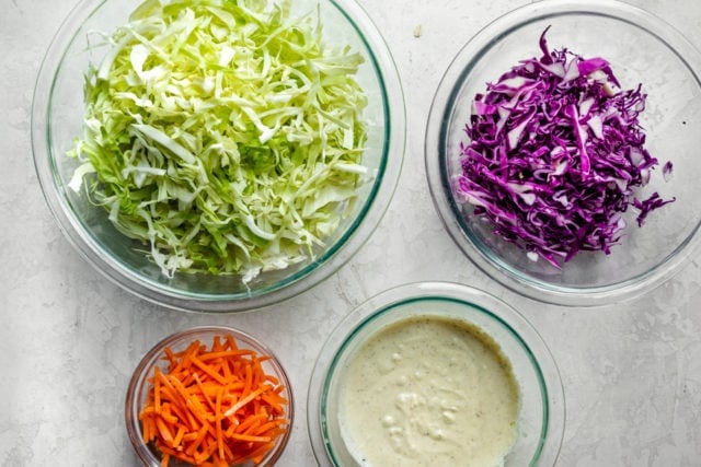 Ingredients to make the recipe: green cabbage, purple cabbage, carrots and the homemade dressing