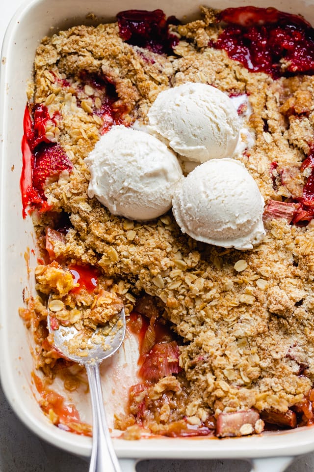 Close up shot of the baking dish with the spoon scooping out some crisp