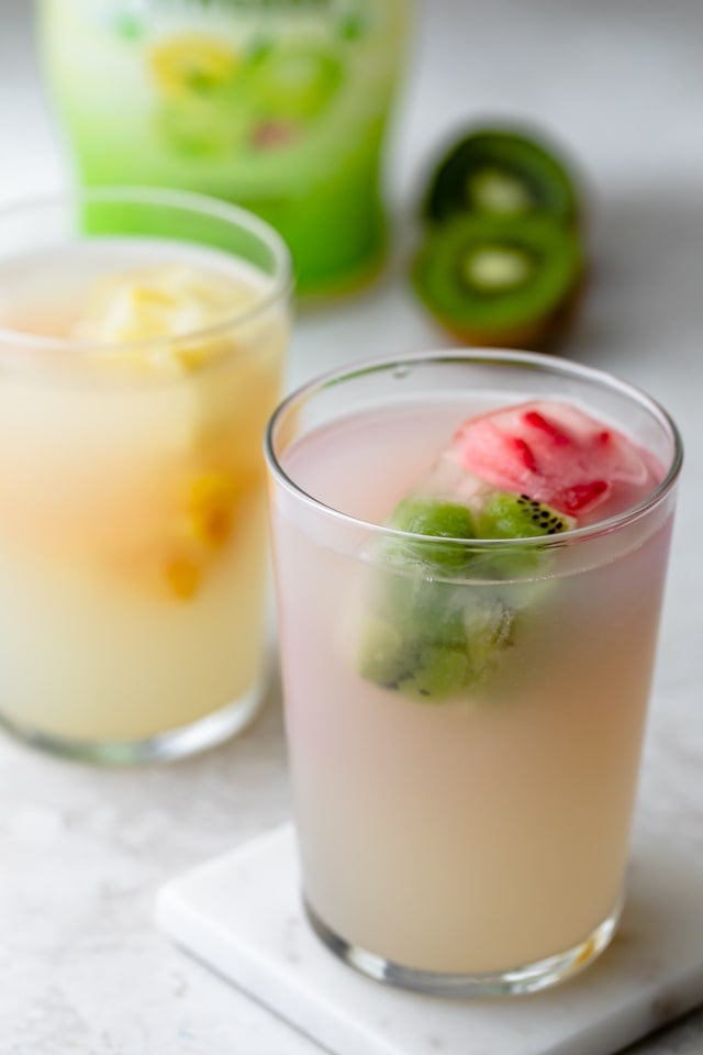 Fruit ice cubes with limeade in two cups