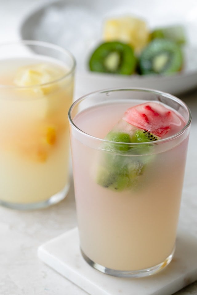 Fruit ice cubes in cups with limeade