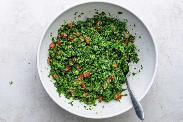 All the ingredients tossed together in a large white bowl