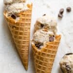 Two waffle cones with almond joy ice cream scoops on top