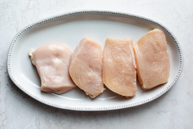4 skinless boneless chicken breasts on a plate