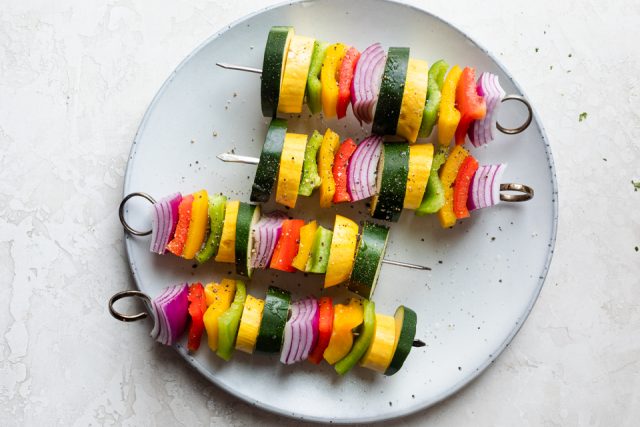 Veggie skewers on a white plate