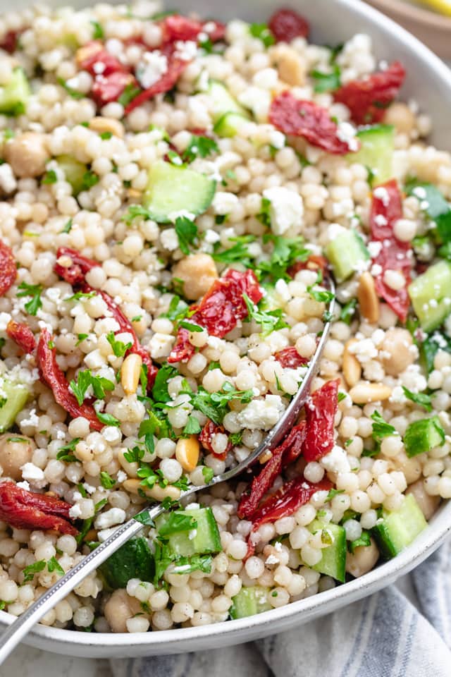 Close up of spoon in salad to show fresh mediterranean ingredients