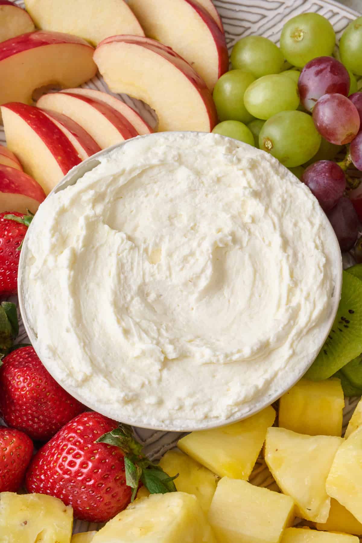 Close up of cream cheese dip on a fruit platter.