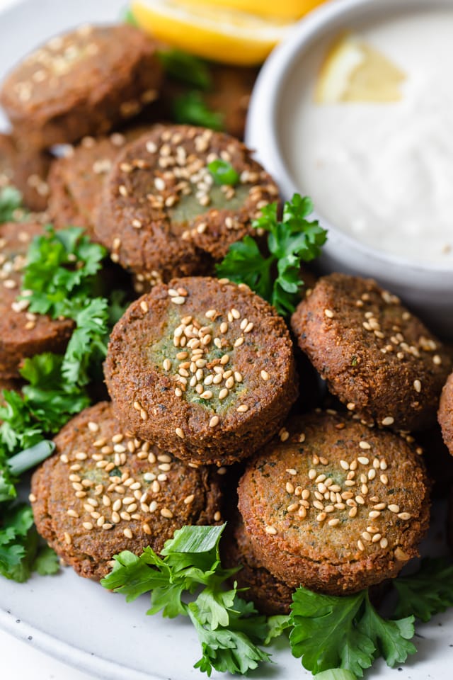 Close up shot of falafel patties with sesame seeds sprinkled on top