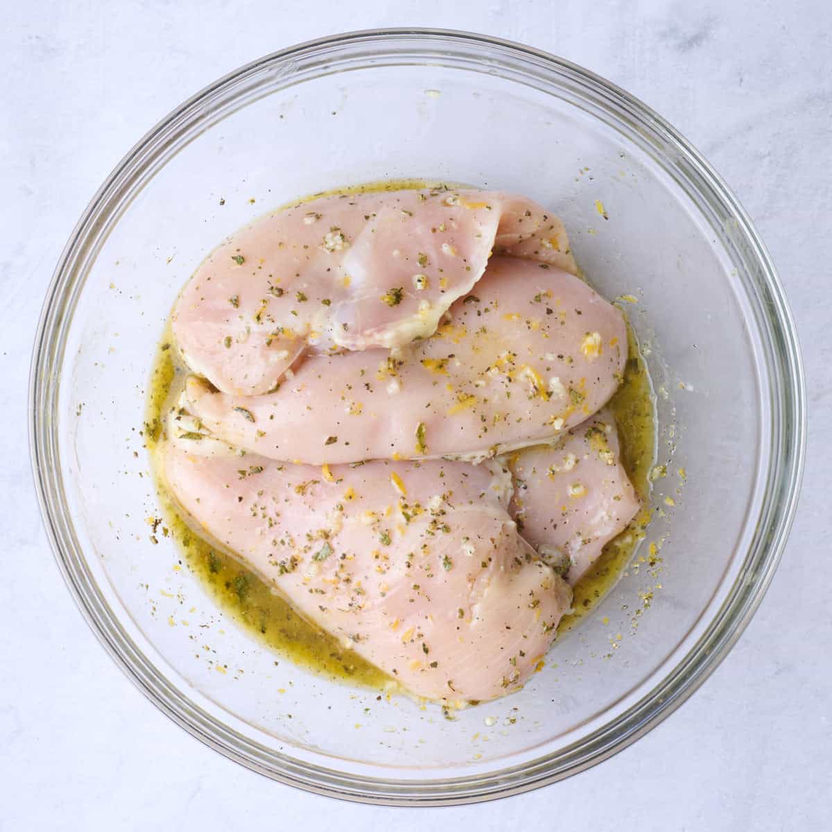 Chicken tossed in marinade.