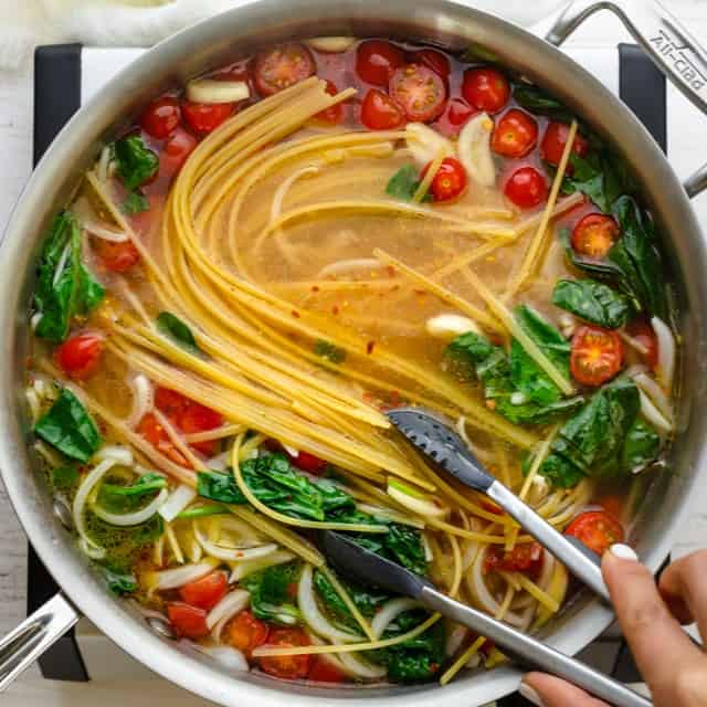 Stirring the contents of the pot.
