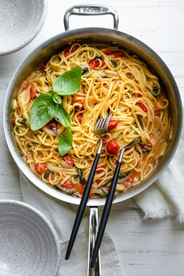 One pan pasta recipe made with spaghetti, tomatoes, spinach, basil, onions and garlic