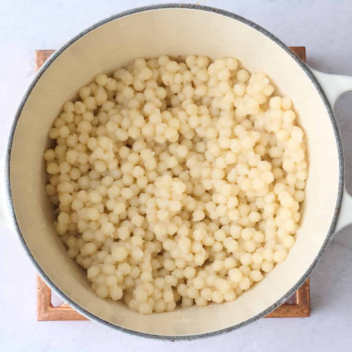 Couscous in pot after cooking and fluffed.