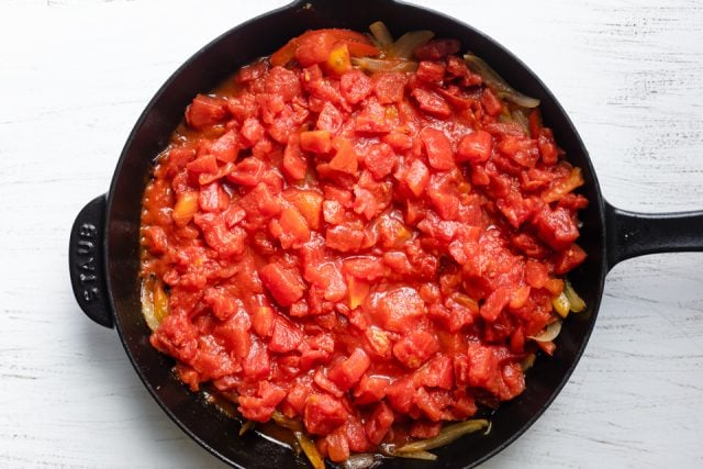 Added tomatoes to the cast iron skillet