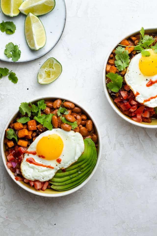 Two tex mex breakfast bowls on a table