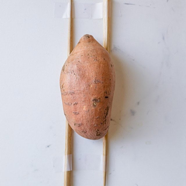 Potato on stick before slicing.