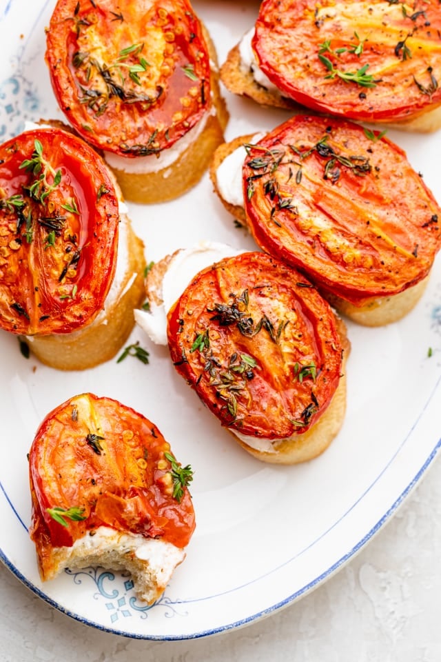 overhead shot of roasted tomatoes on crostinis