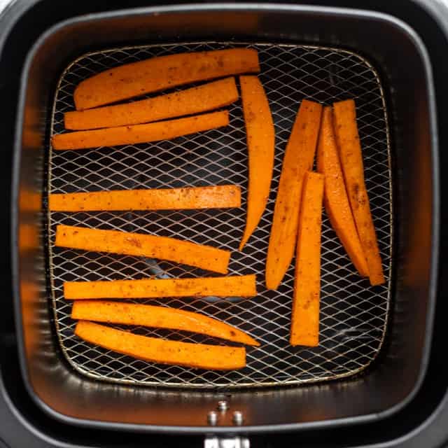 Sweet potato fries in air fryer before cooked.