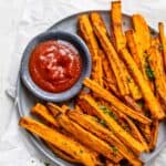 Air fryer sweet potato fries served with ketchup on a plate