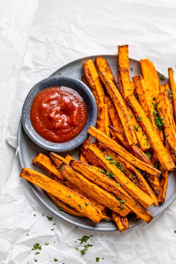 Air fryer sweet potato fries served with ketchup on a plate