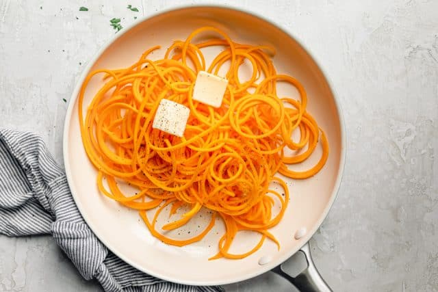 Noodles from butternut squash on a pan with butter