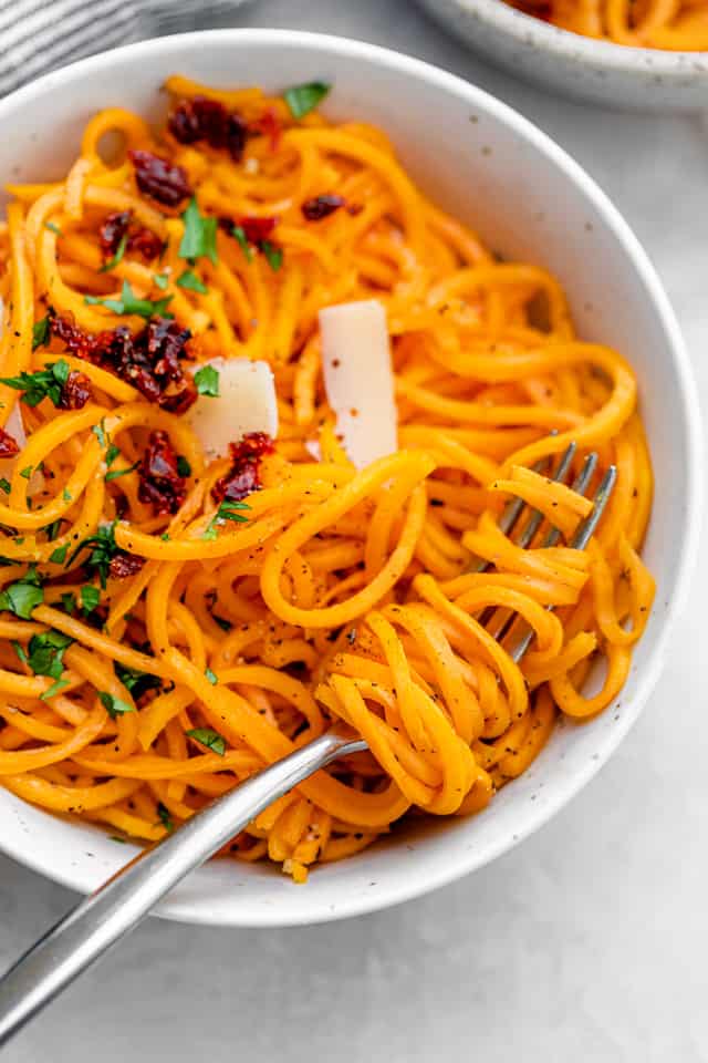 Close up shot of fork twirling the squash noodles 