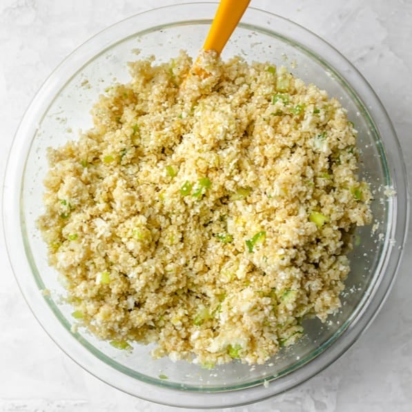 Ingredients to make cauliflower fritters in a bowl after mixing.