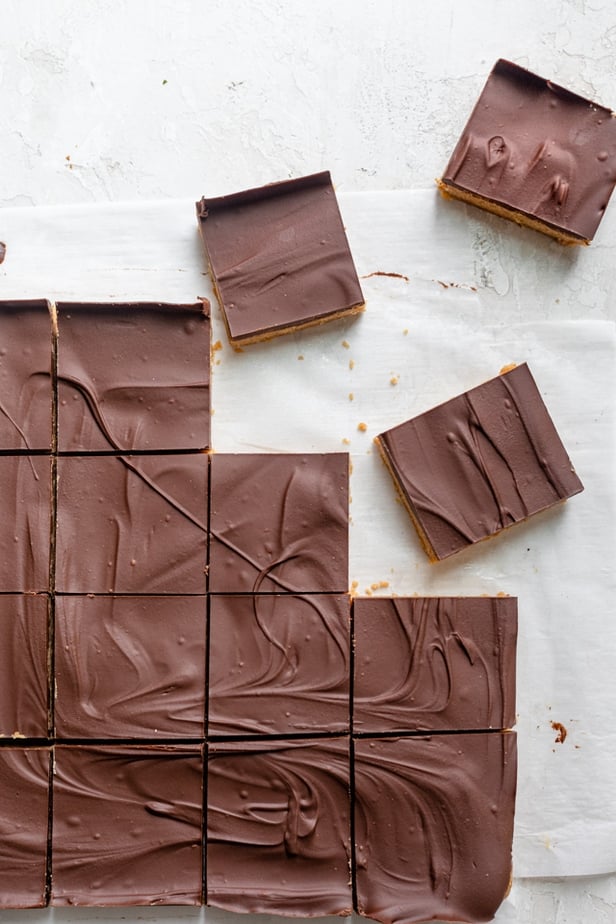 Cutting up the bars into squares on parchment paper