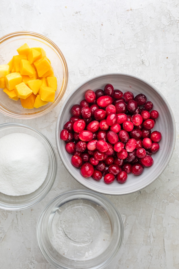 Ingredients to make recipe: cranberries, mango, sugar and water