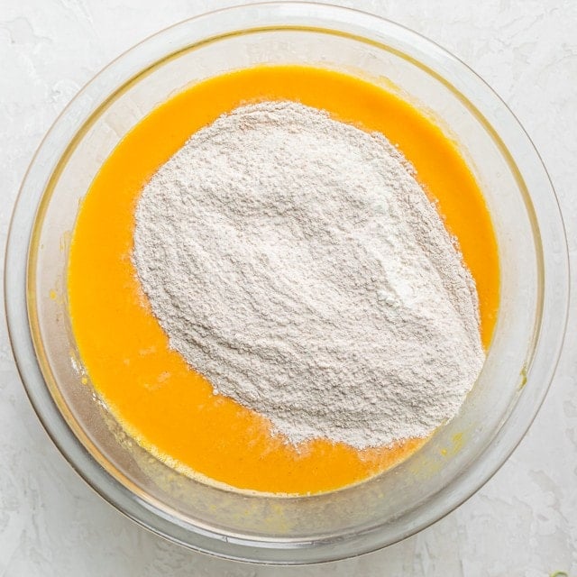 Dry ingredients poured over wet ingredients before mixing.