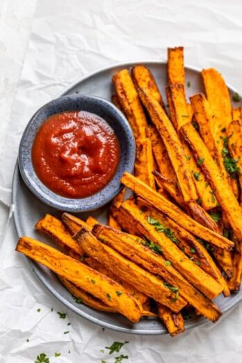 Air fryer sweet potato fries served with ketchup on a plate