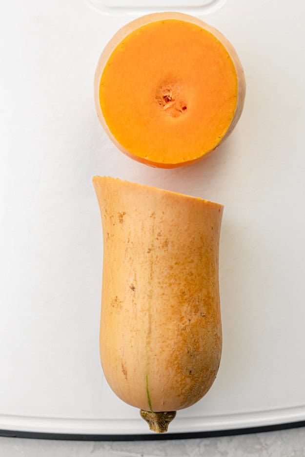A butternut squash with an end cut off.