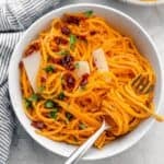 A bowl of butternut squash noodles with a fork resting inside.