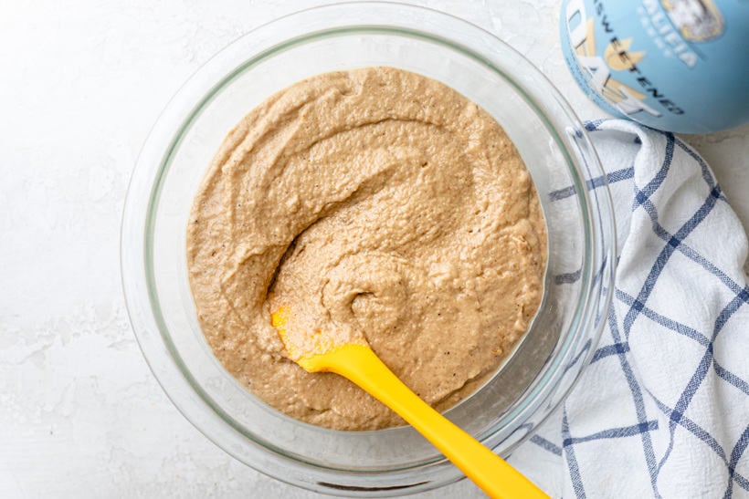 glass bowl with muffin mix being stirred