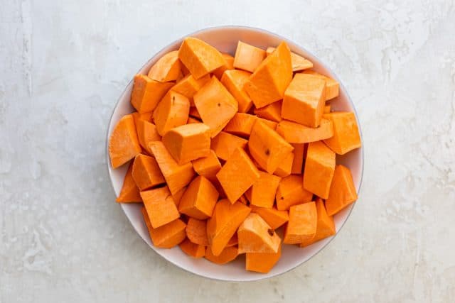 Peeled and chopped sweet potatoes in a large bowl