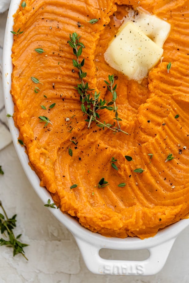 Close up of the mashed sweet potatoes topped with butter