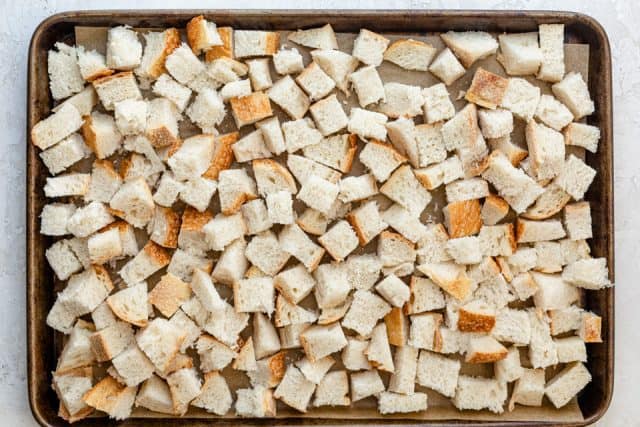 Bread cubes on a baking sheet