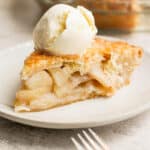Slice of easy apple pie served a la mode with ice cream on top