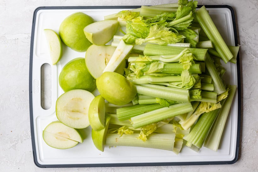 Celery and apples washed and chopped on a cutting board