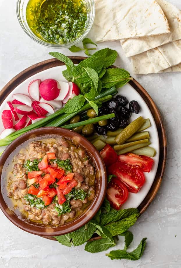 Lebanese ful medames recipe for breakfast served with fresh vegetables and pita