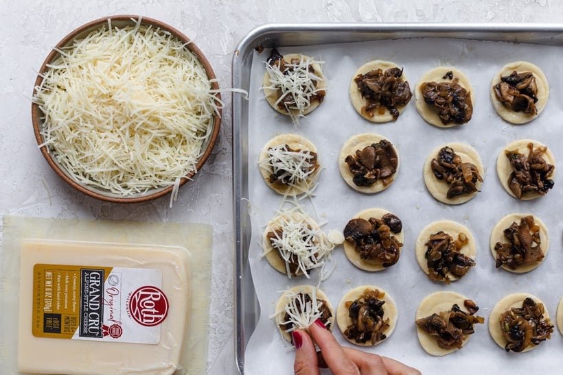 Adding cheese on top of the mushroom puff pastry