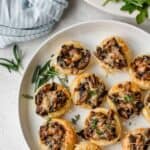 Plate of mushroom tartlets garnished with rosemary