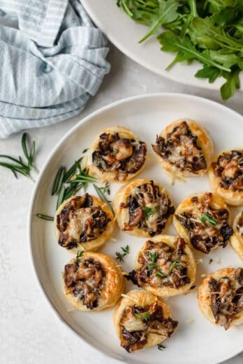 Plate of mushroom tartlets garnished with rosemary